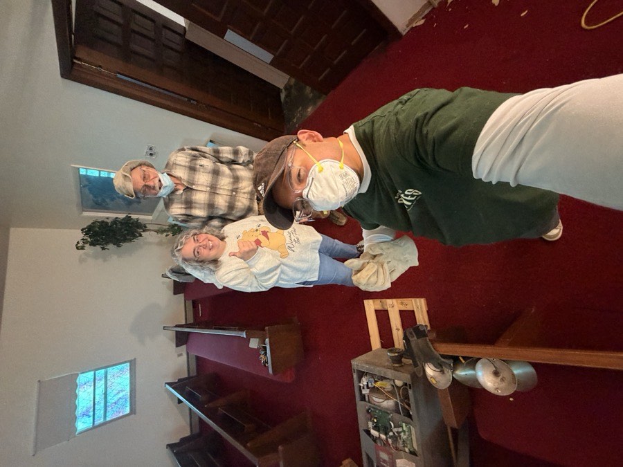 Pastor working alongside volunteers in the sanctuary